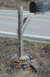 Mailbox post set into rocks.